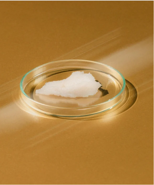 A pietre dish with solid white product inside on a honey wood background. 