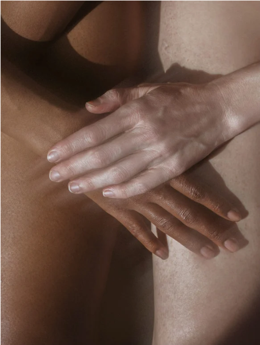 Close-up of a hand gently touching another person's skin