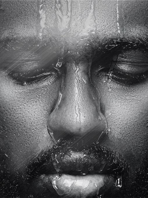 Close-up of a person's face with water droplets on a textured surface