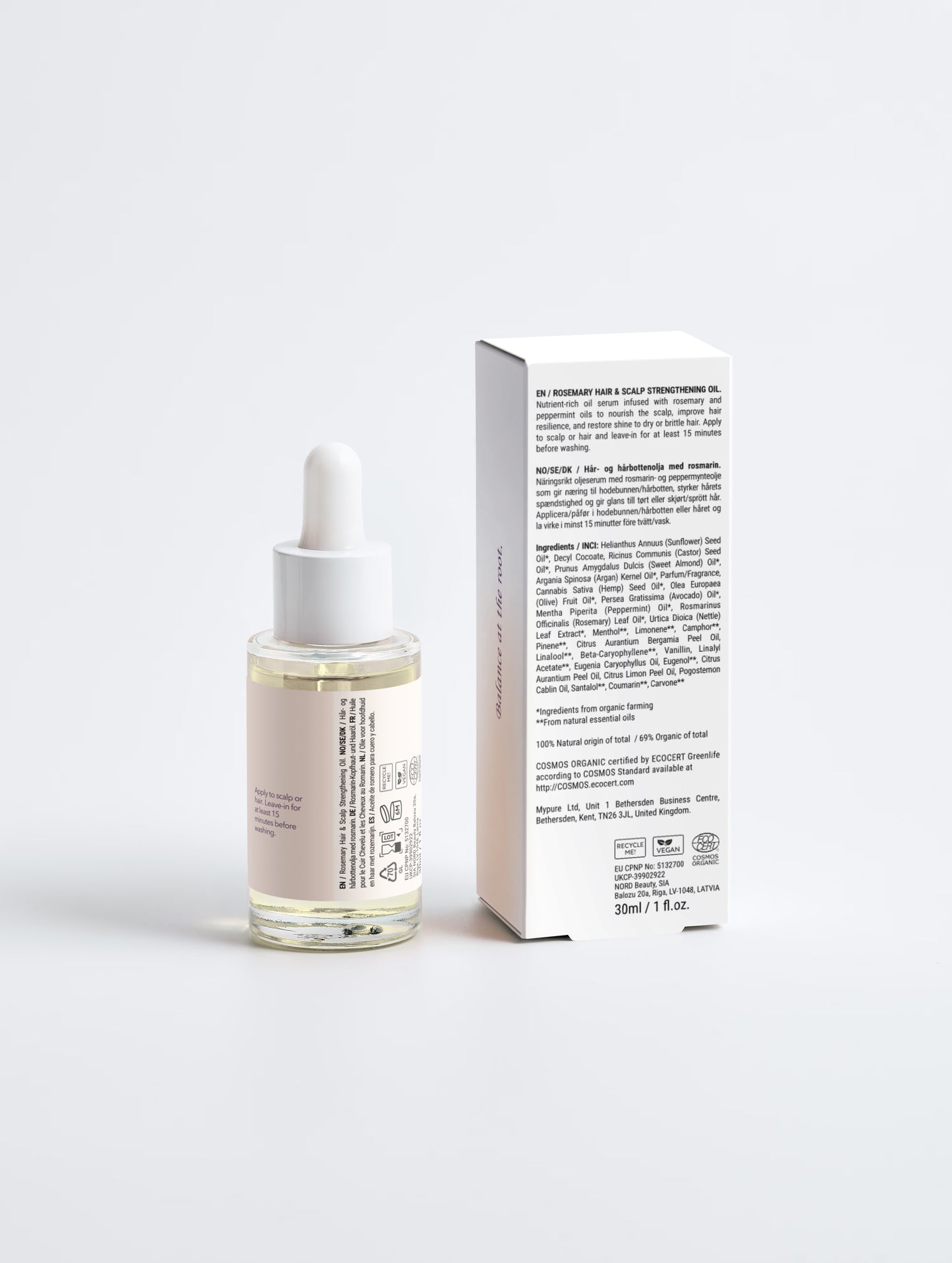 Skincare serum bottle with dropper and its packaging on a light gray background