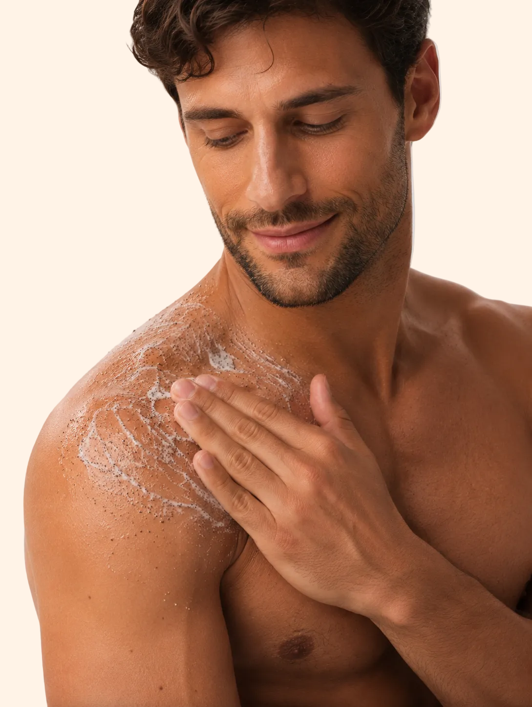 Man applying a white cream or lotion to his shoulder against a plain background