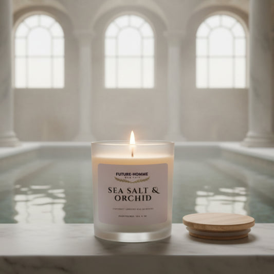 Candle labeled 'Sea Salt & Orchid' on a marble surface with a neutral background