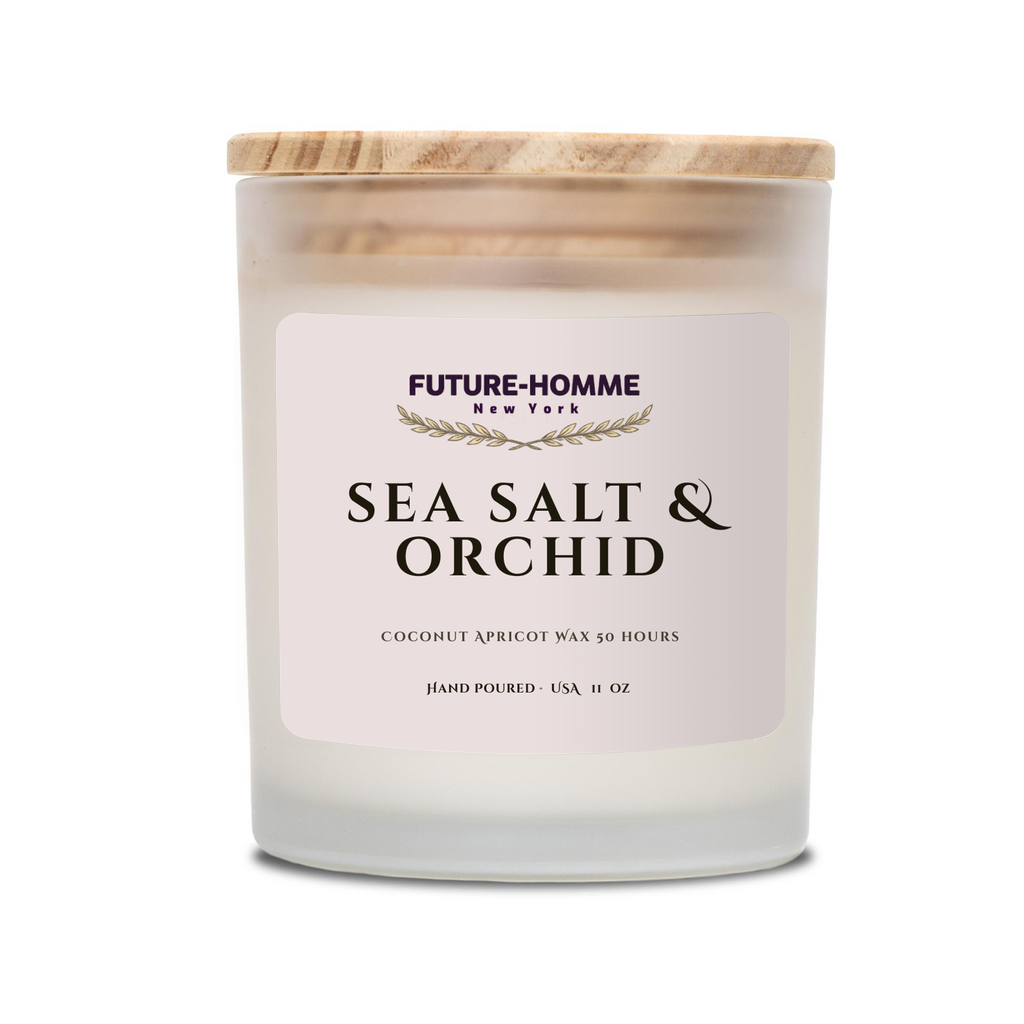 A Future-Homme frosted glass candle scented in sea salt and orchid on a white background. 