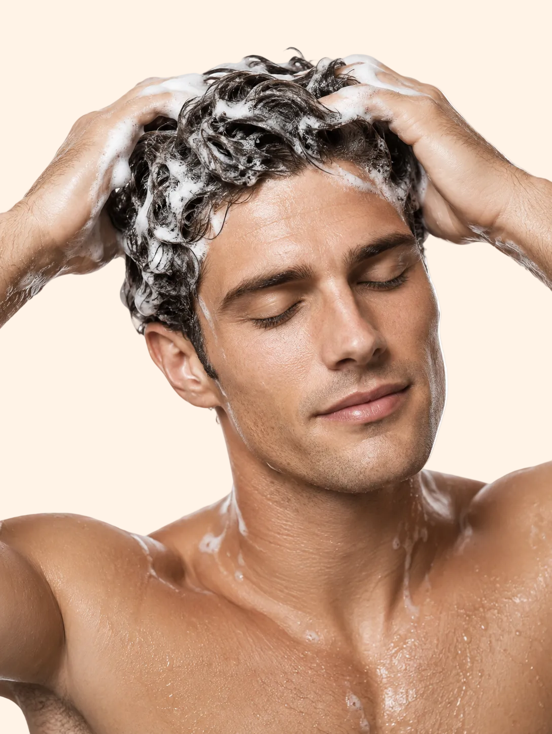 Man washing his hair with shampoo against a white background