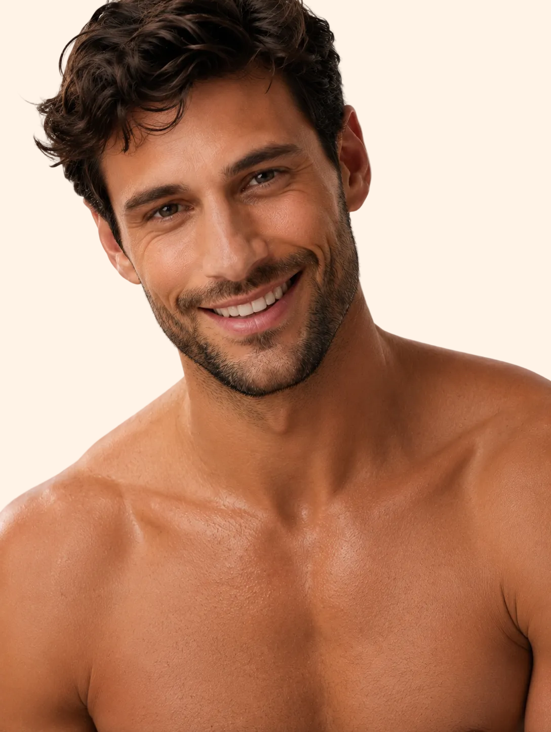 Man with a beard and short hair smiling on a plain background