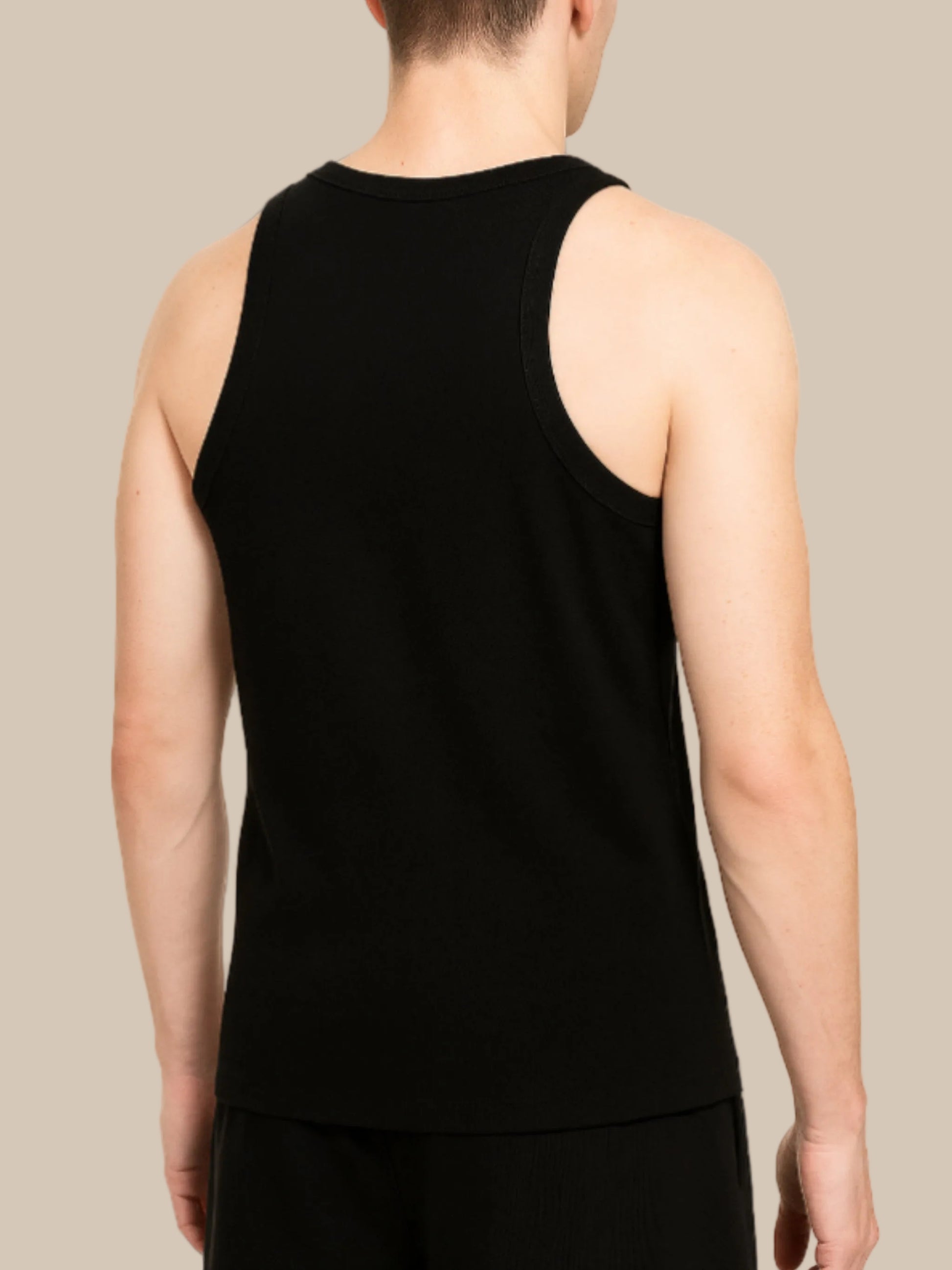 Person wearing a black tank top on a white background