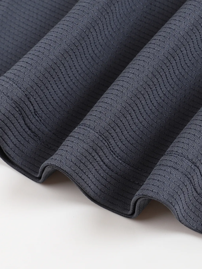 Close-up of dark blue textured fabric on a light background