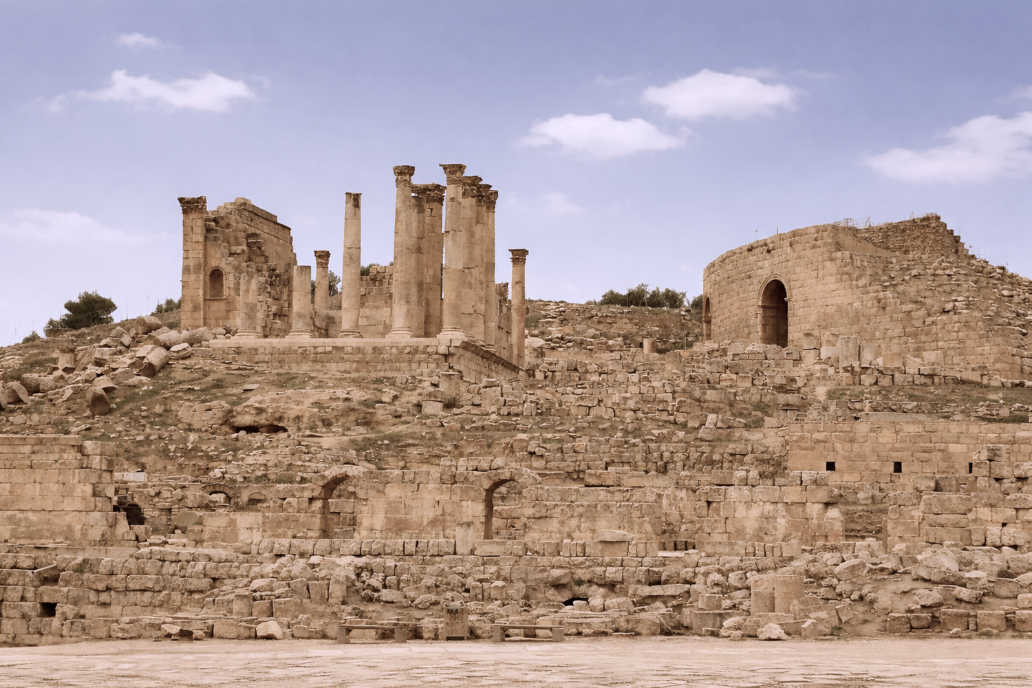 Ancient stone ruins with columns and arches under a clear blue sky.