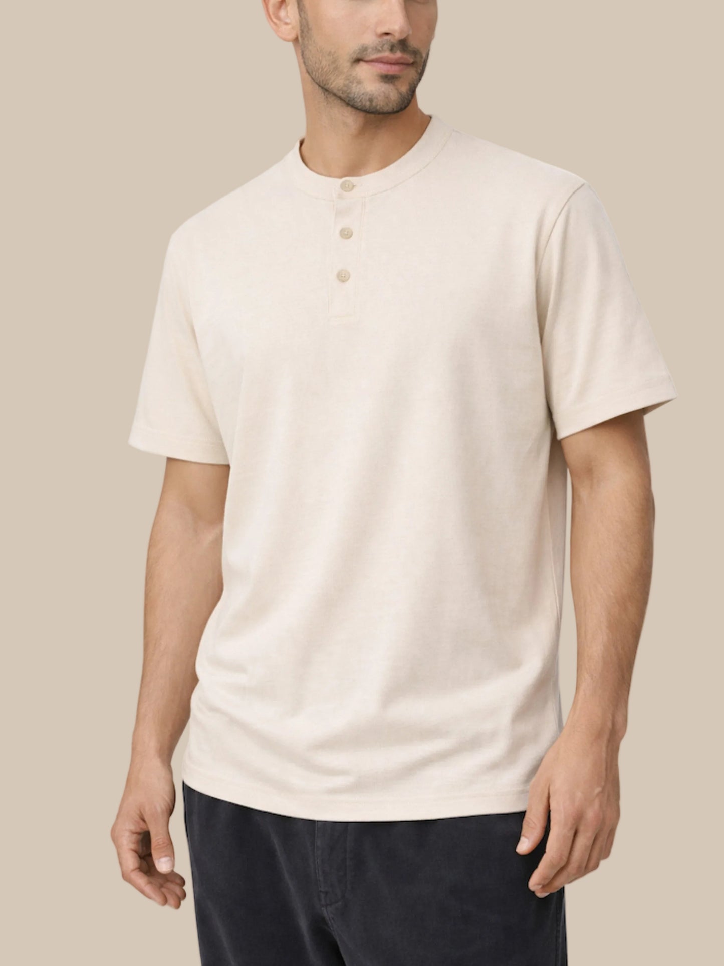 Man wearing a beige short-sleeve henley shirt on a white background