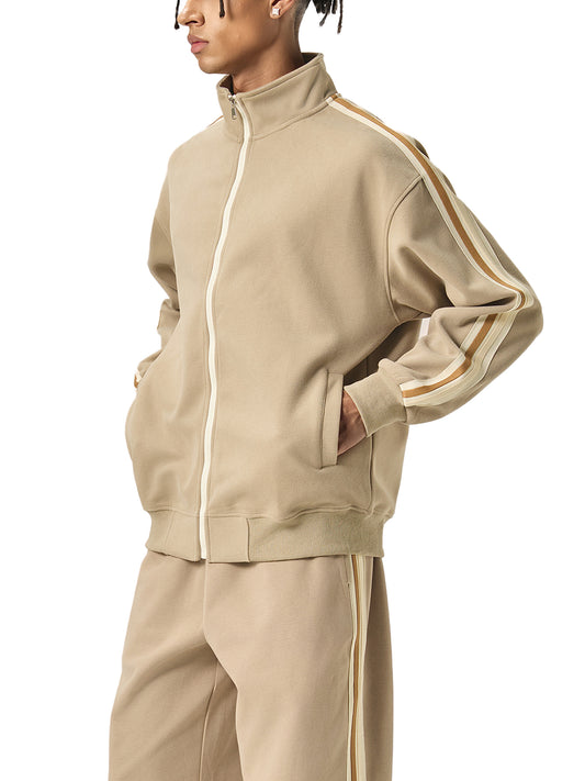 A model wearing a Future-Homme beige Track Zip up Jacket and matching pants 340 GSM sustainably made-to-order side view on a white background