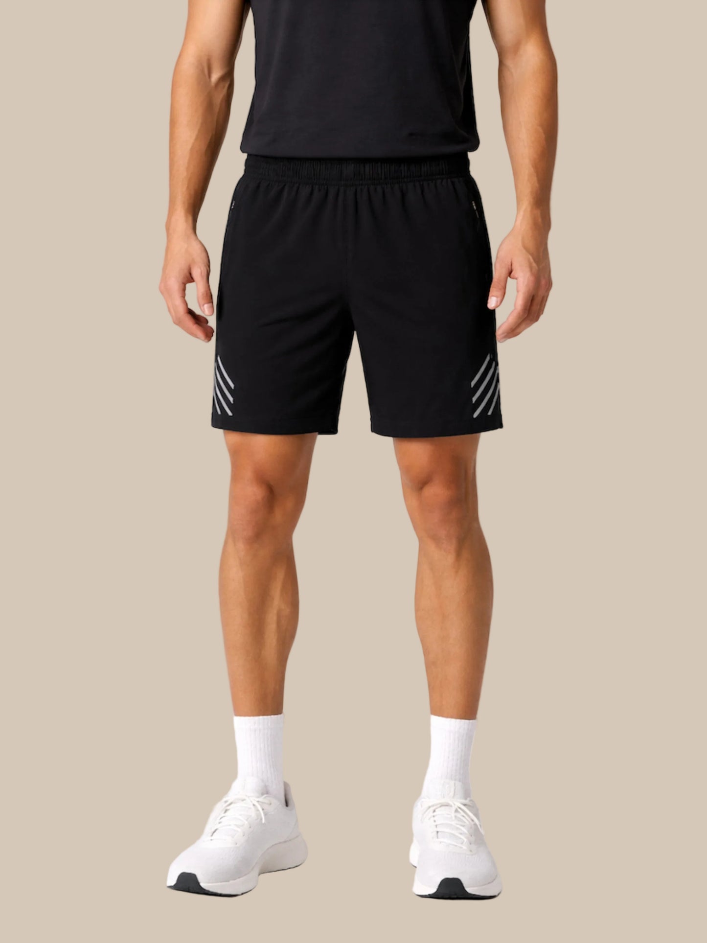 Person wearing black athletic shorts with white stripes on a white background