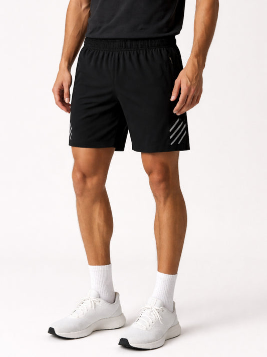 Person wearing black athletic shorts with white stripes on a white background
