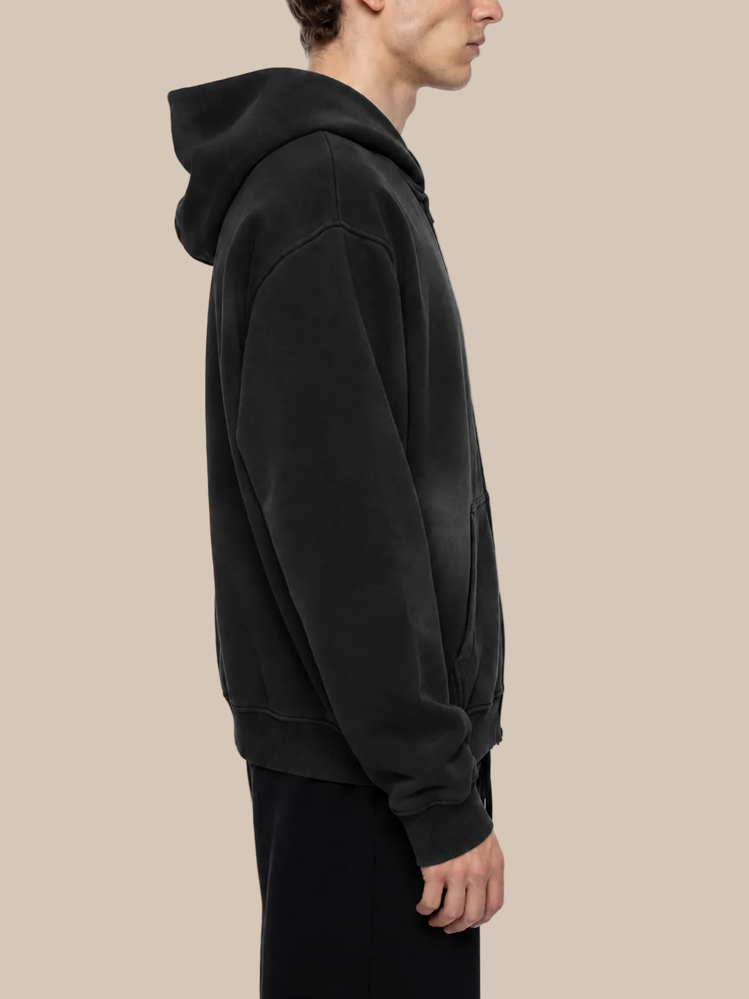 Person wearing a black hoodie on a white background