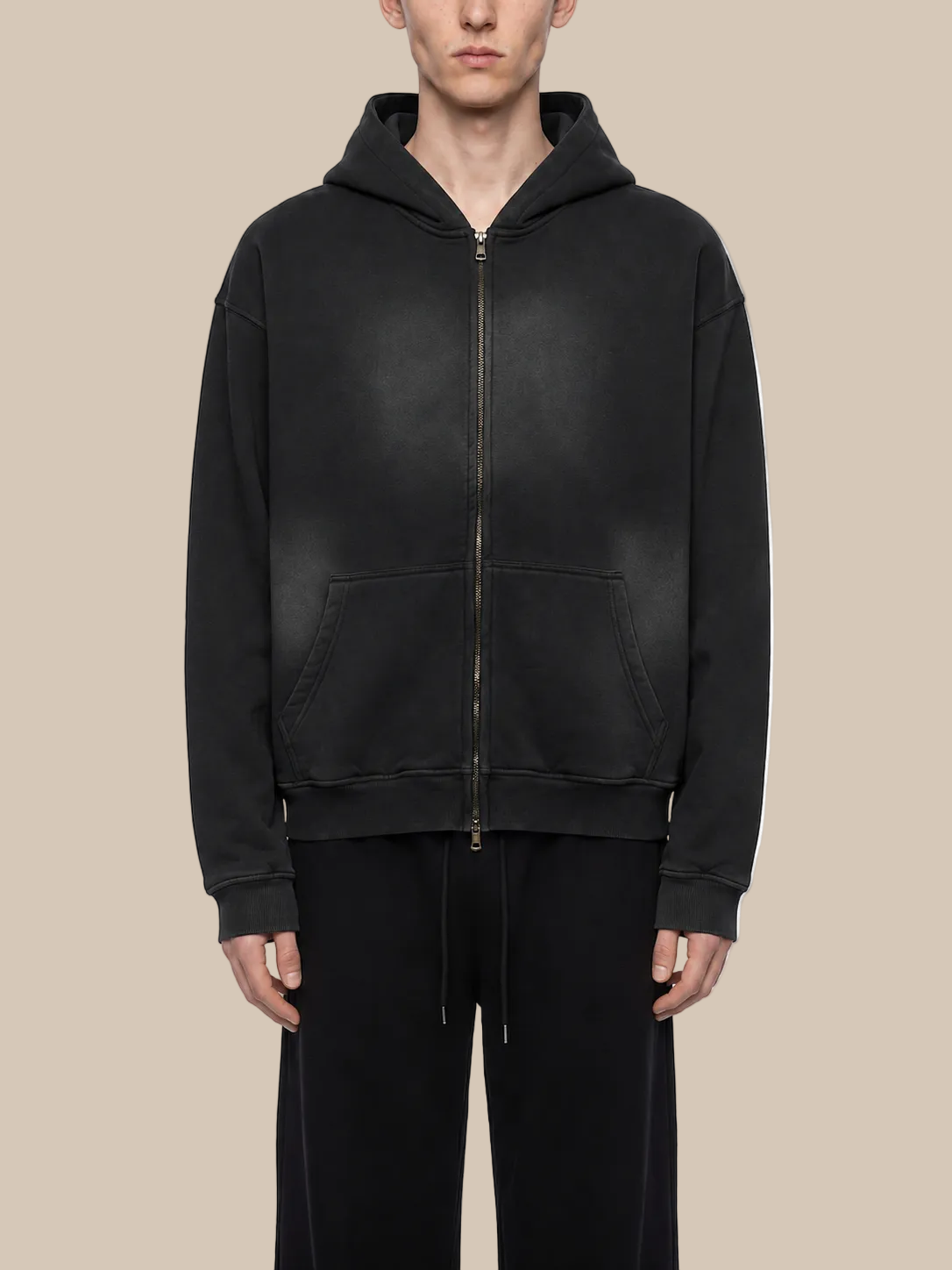Person wearing a black hoodie on a white background