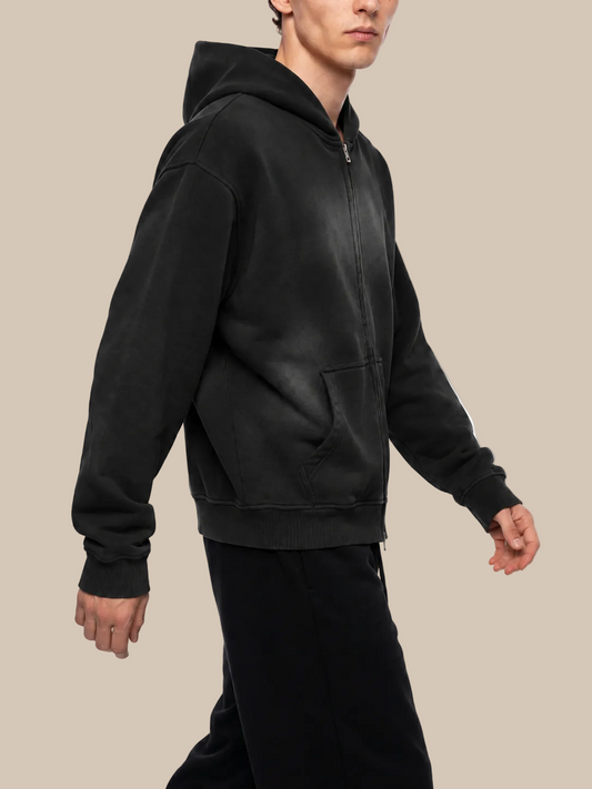 Person wearing a black hoodie on a white background