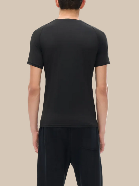 Person wearing a black technical performance t-shirt and pants on a white background