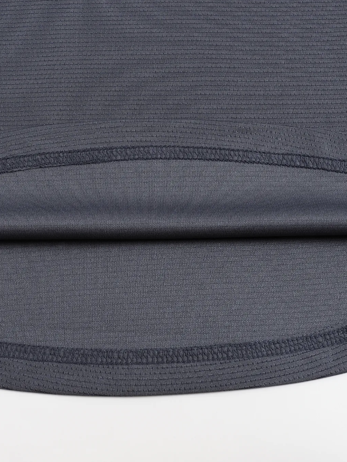 Close-up of a gray athletic shirt with mesh panels on a white background