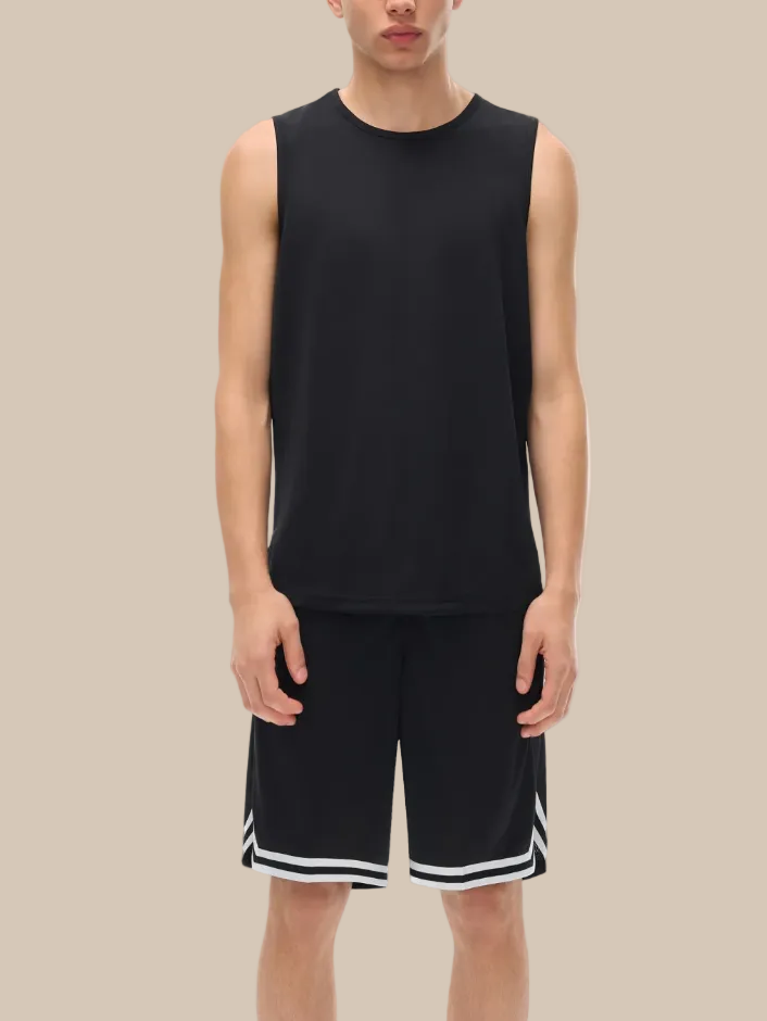Person wearing a black sleeveless shirt and black shorts with white trim on a white background
