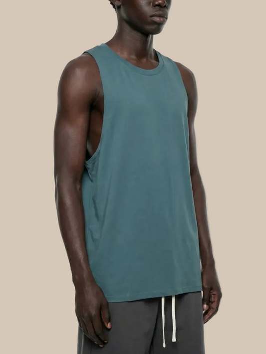 Man wearing a teal sleeveless shirt on a white background