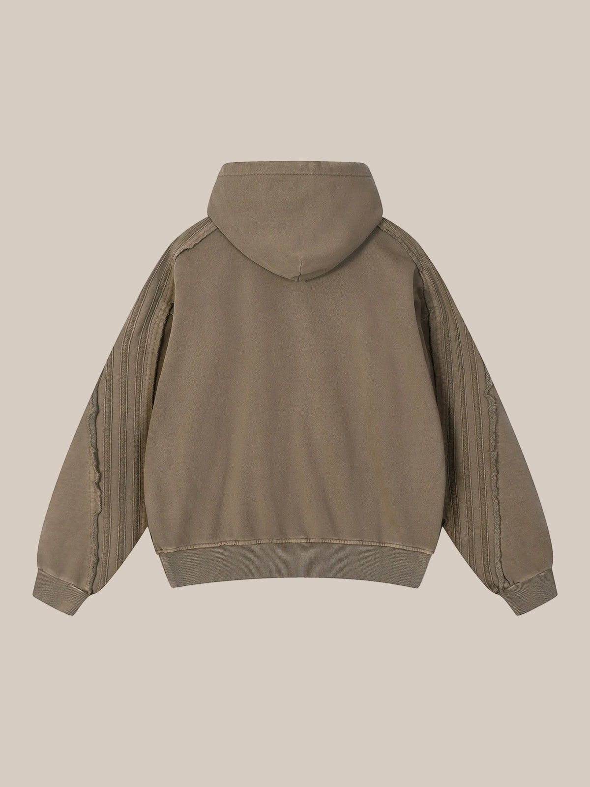 Flat lay of the back of a hoodie on a beige background. 