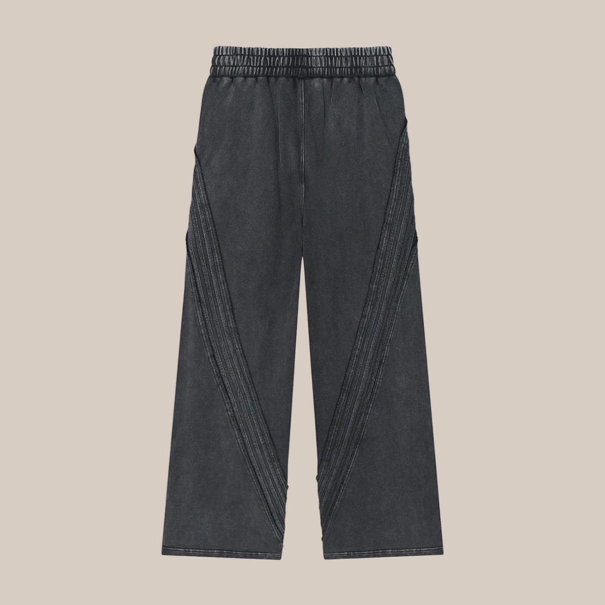 Black sweatpants on a beige background. 