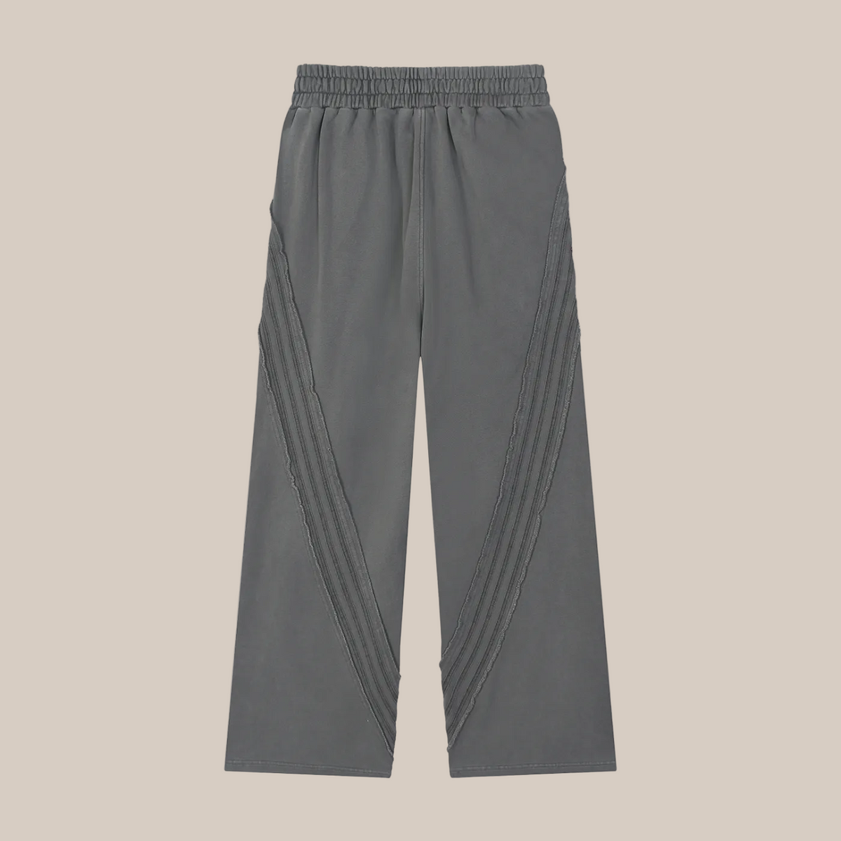 Gray pants with pleated sides on a beige background