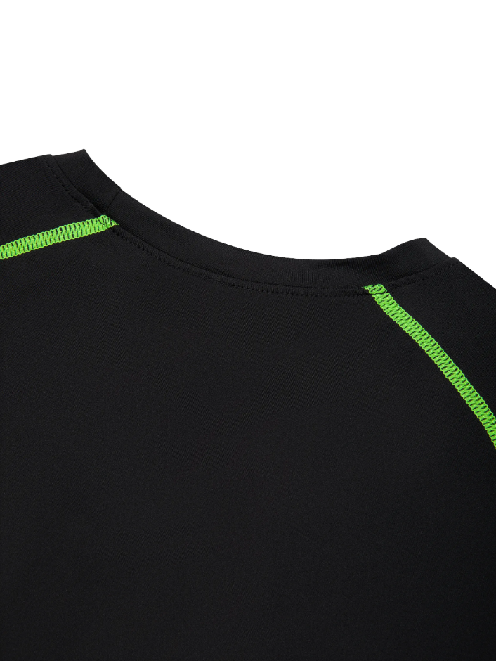 Up close detail shot of the training t-shirt neckline in black with green accents on a white background. 