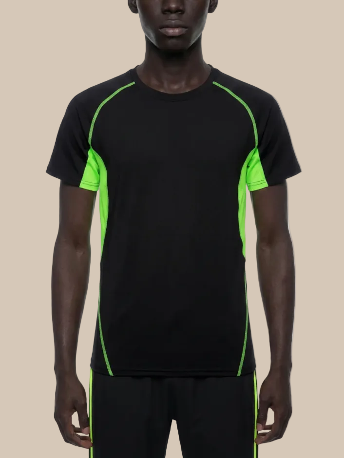 A man wearing a contrast panel training t-shirt in black and neon green on a beige background. 