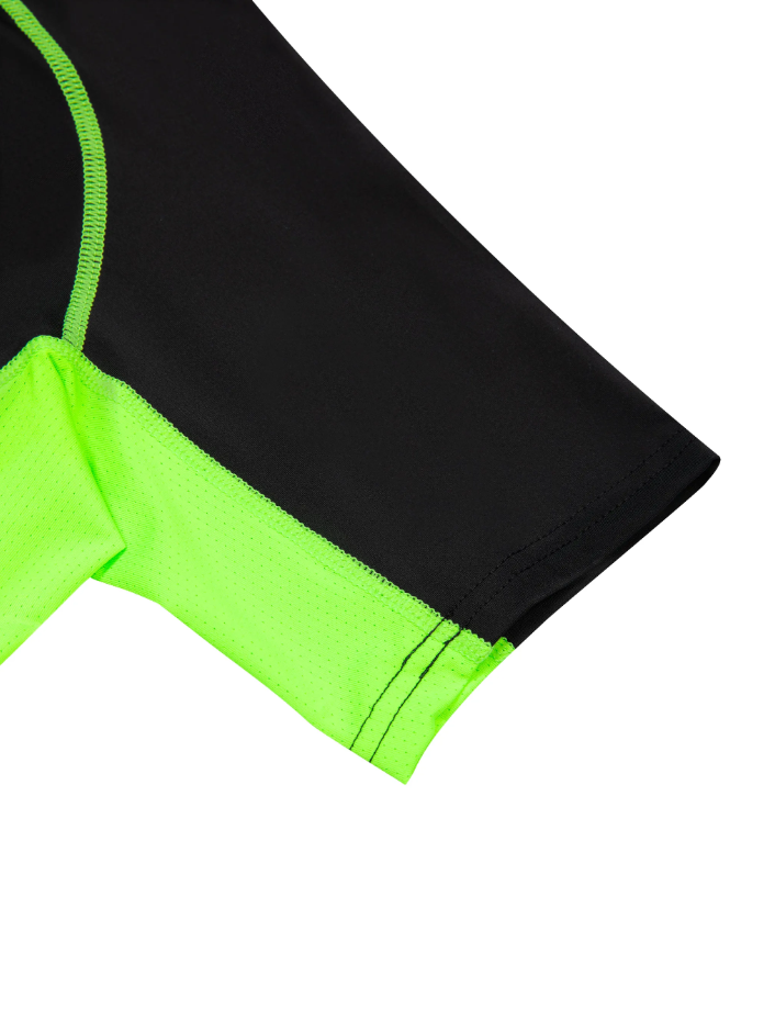 Up close image of the sleeve of the training t-shirt in black with green accents on a white background. 