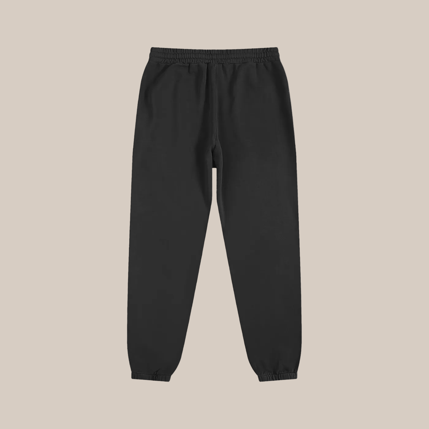 Black sweatpants on a beige background