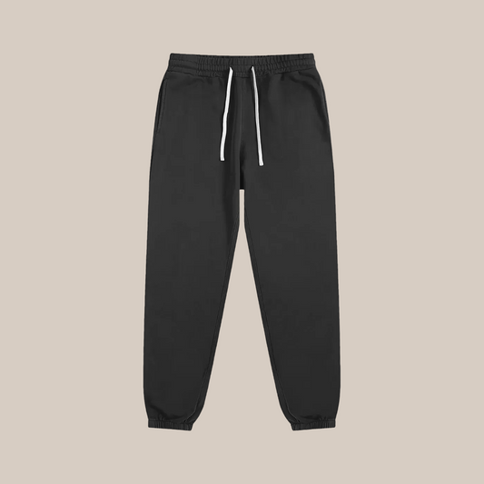 Black sweatpants with a white drawstring on a white background