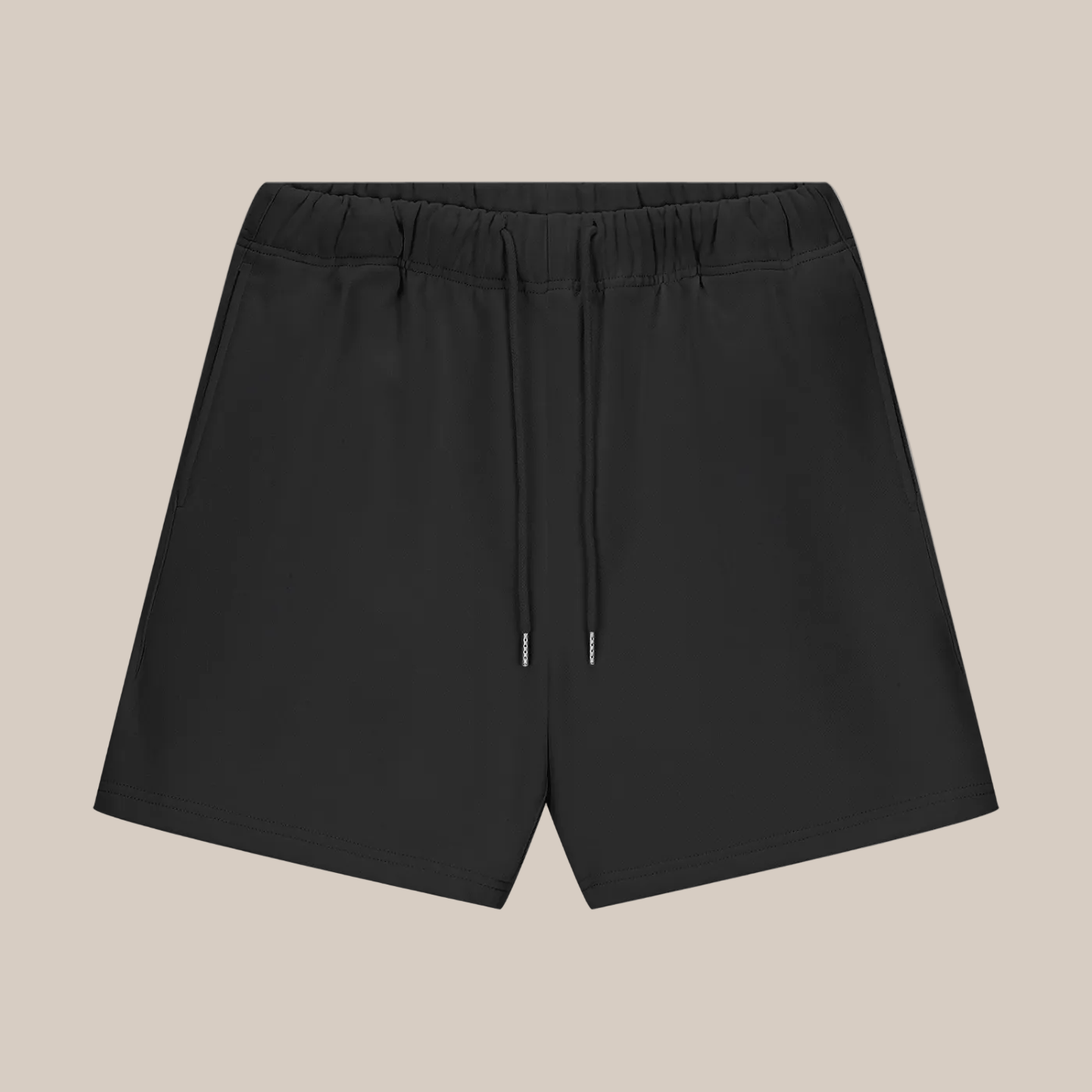 Black shorts with drawstring on a beige background