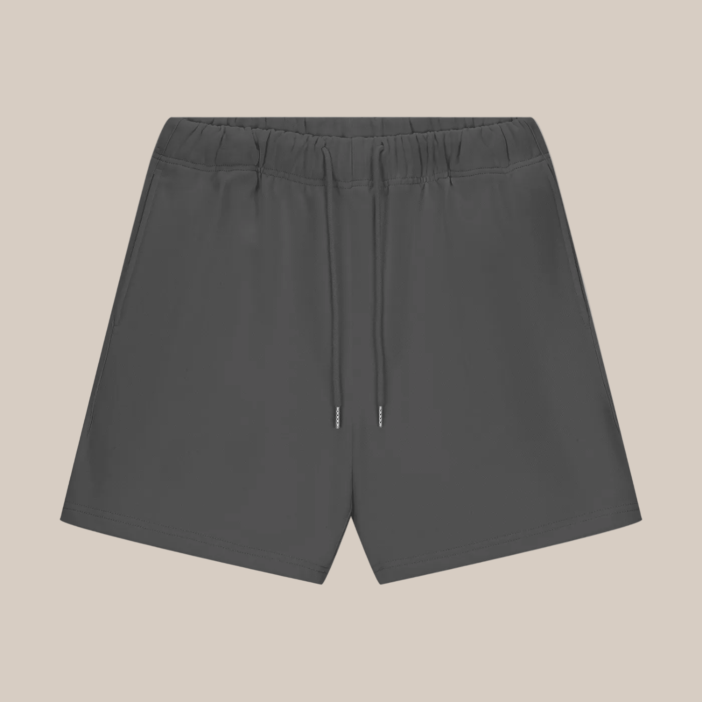 Dark gray shorts with a drawstring on a beige background