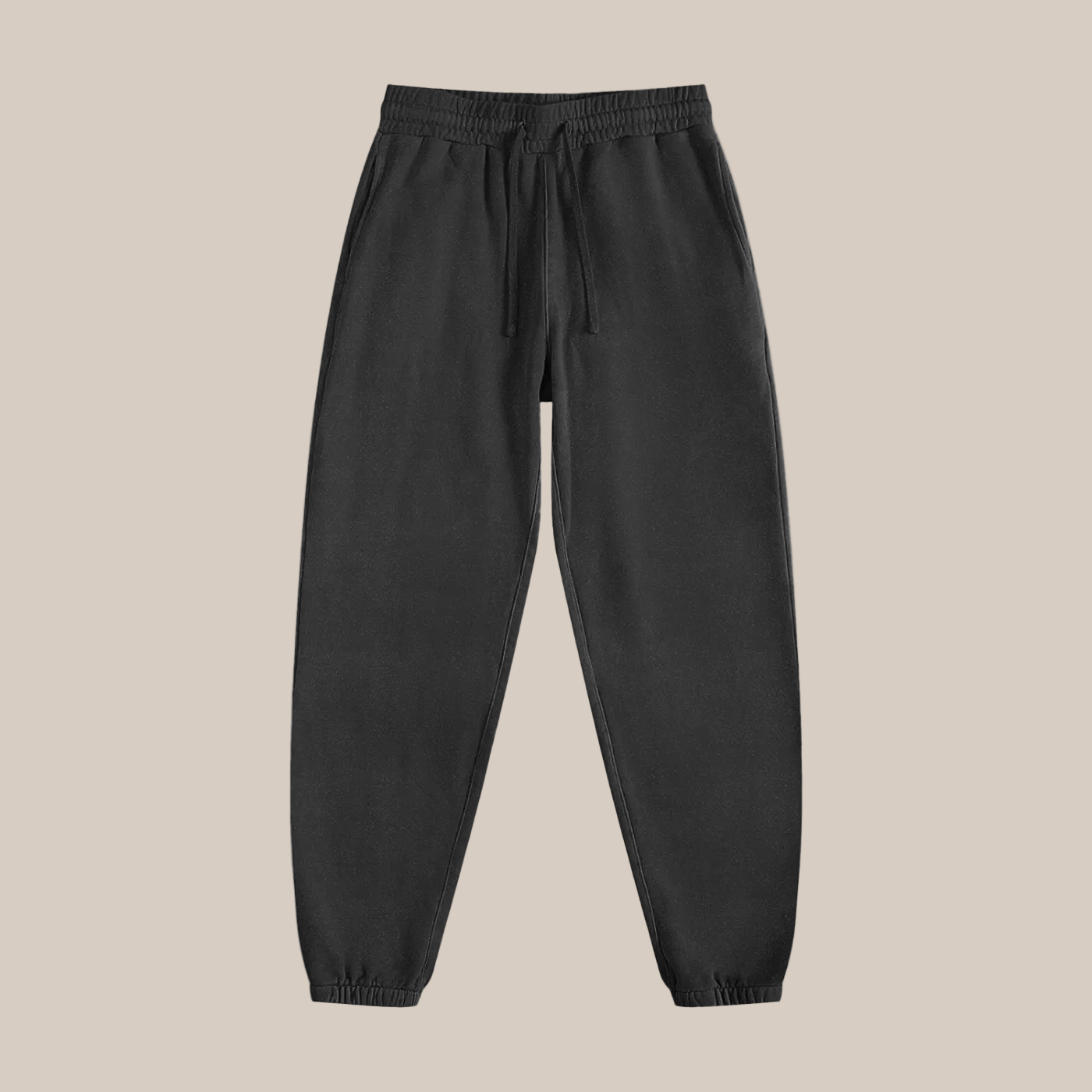 Black sweatpants on a beige background