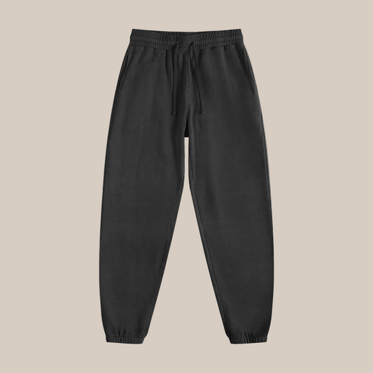 Black sweatpants on a beige background