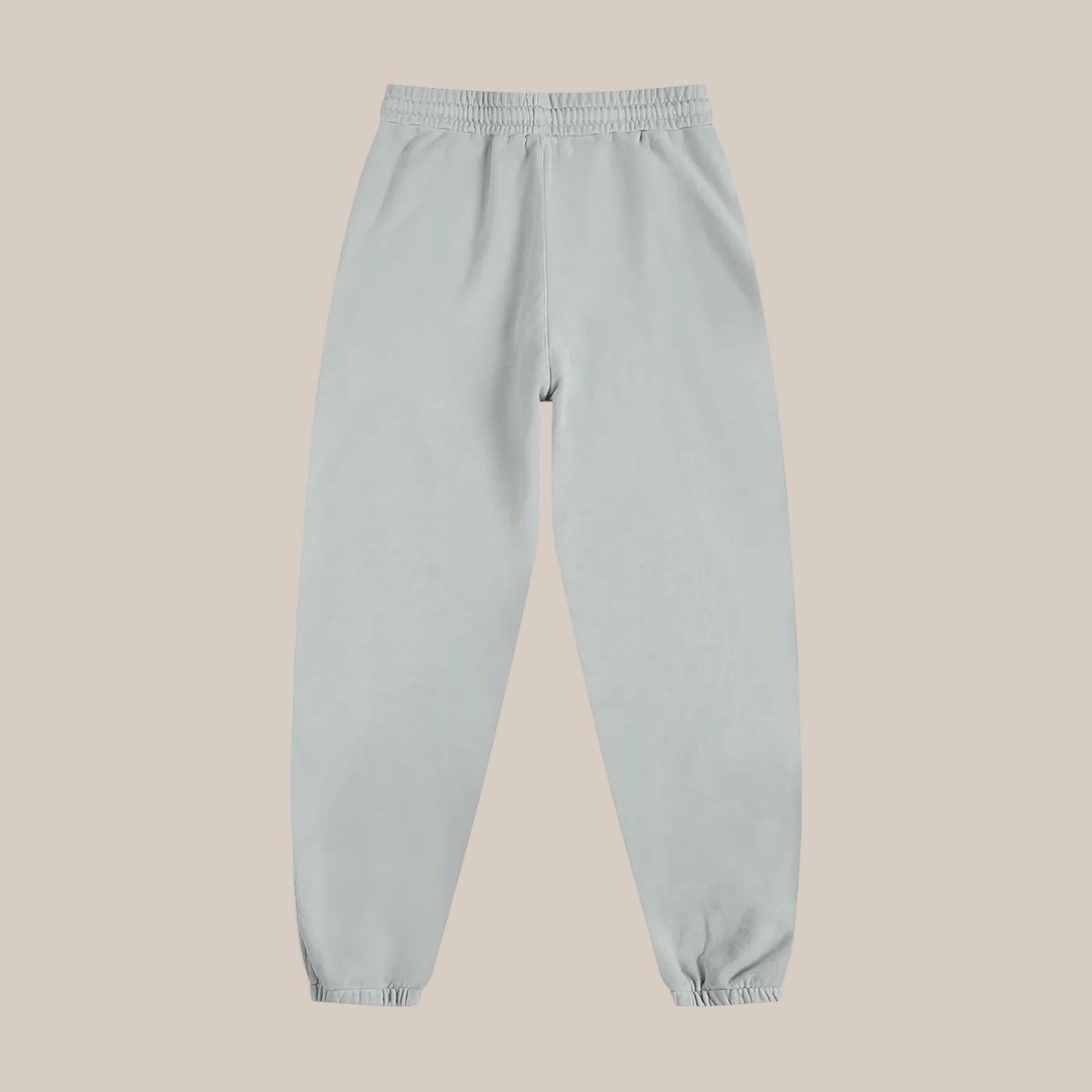 Light gray sweatpants on a beige background