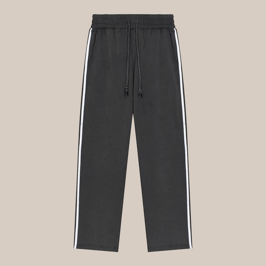 Black pants with white stripes on a beige background